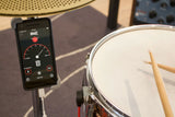 Backbeater Deluxe in action measuring drum tempo on smartphone